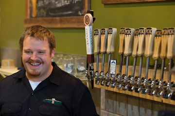 Brad Gilbert stands in front of Pateros Creek Brewing Company's line of draught beverages - which now includes Conundrum Coffee Nitro - a cold, non-alcoholic coffee drink.